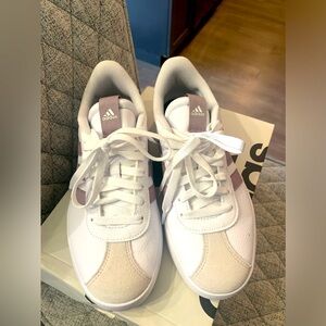 Adidas woman’s shoes.  White and purple